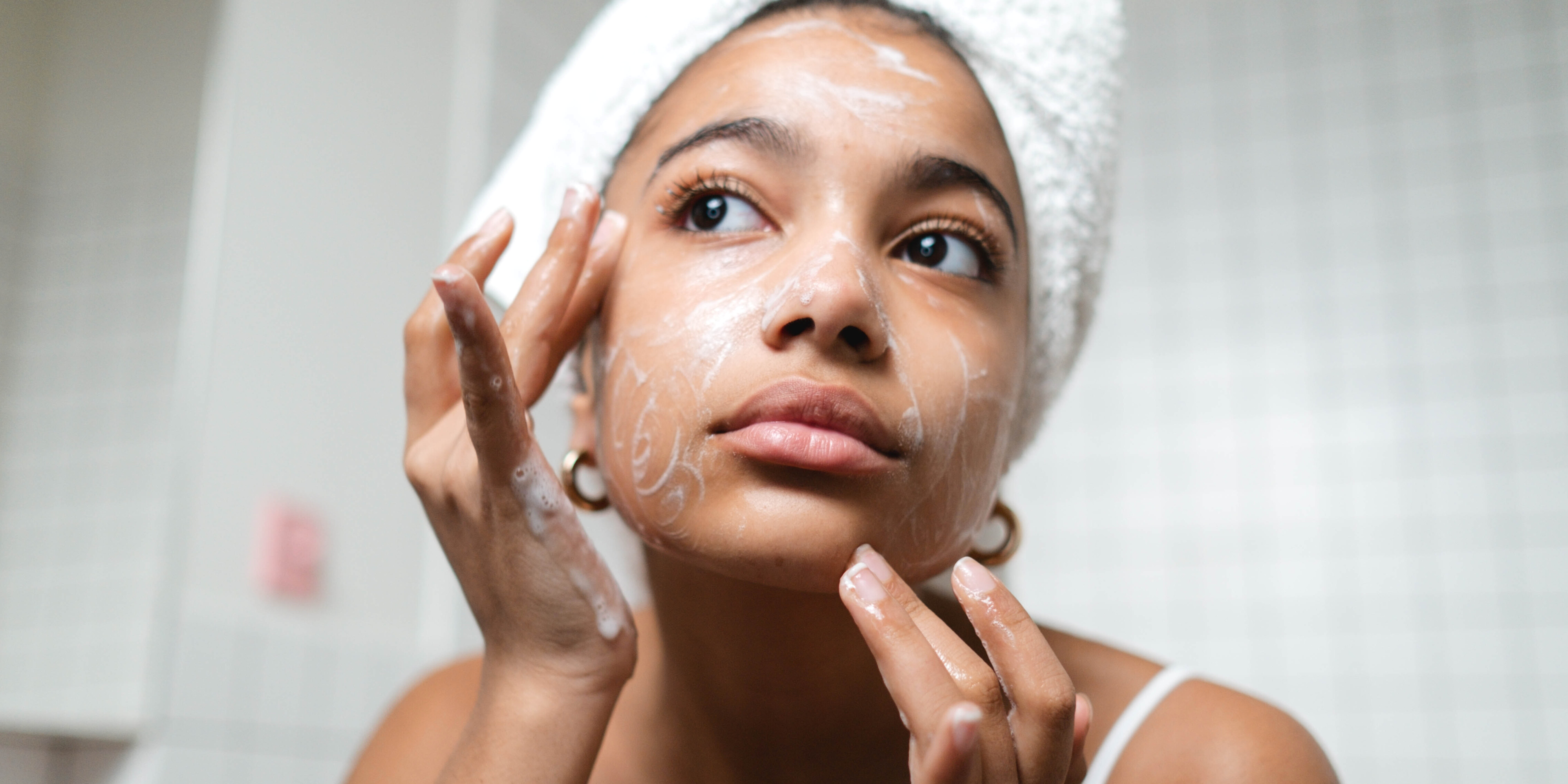 Woman doing a double cleanse to minimise the appearance of her pores