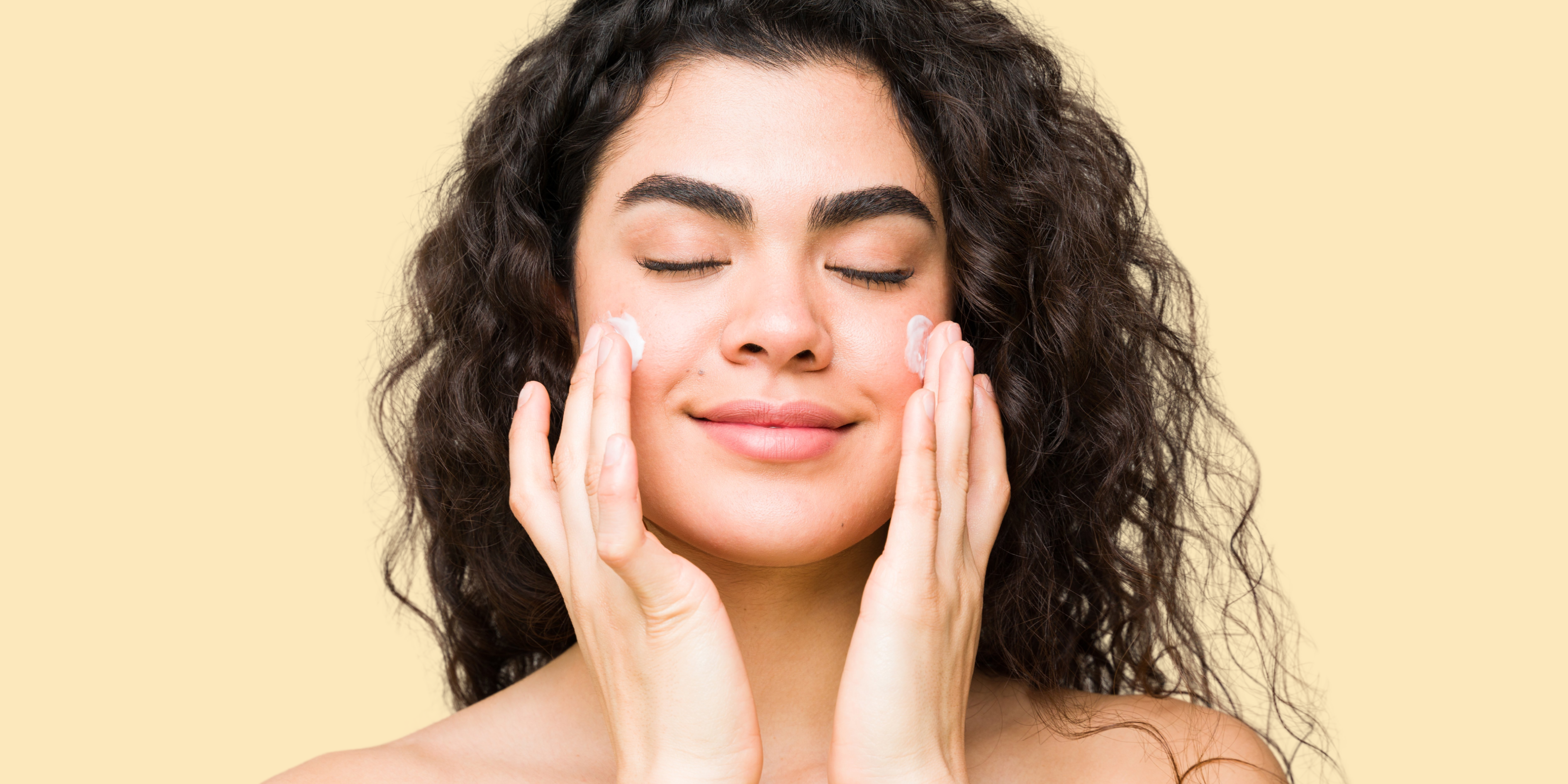 Woman putting on Niacinimide to help fight her breakouts