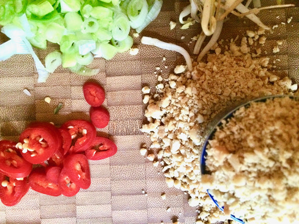 Vegan Pad Thai - Chili, Chopped Peatnuts and sprouts.