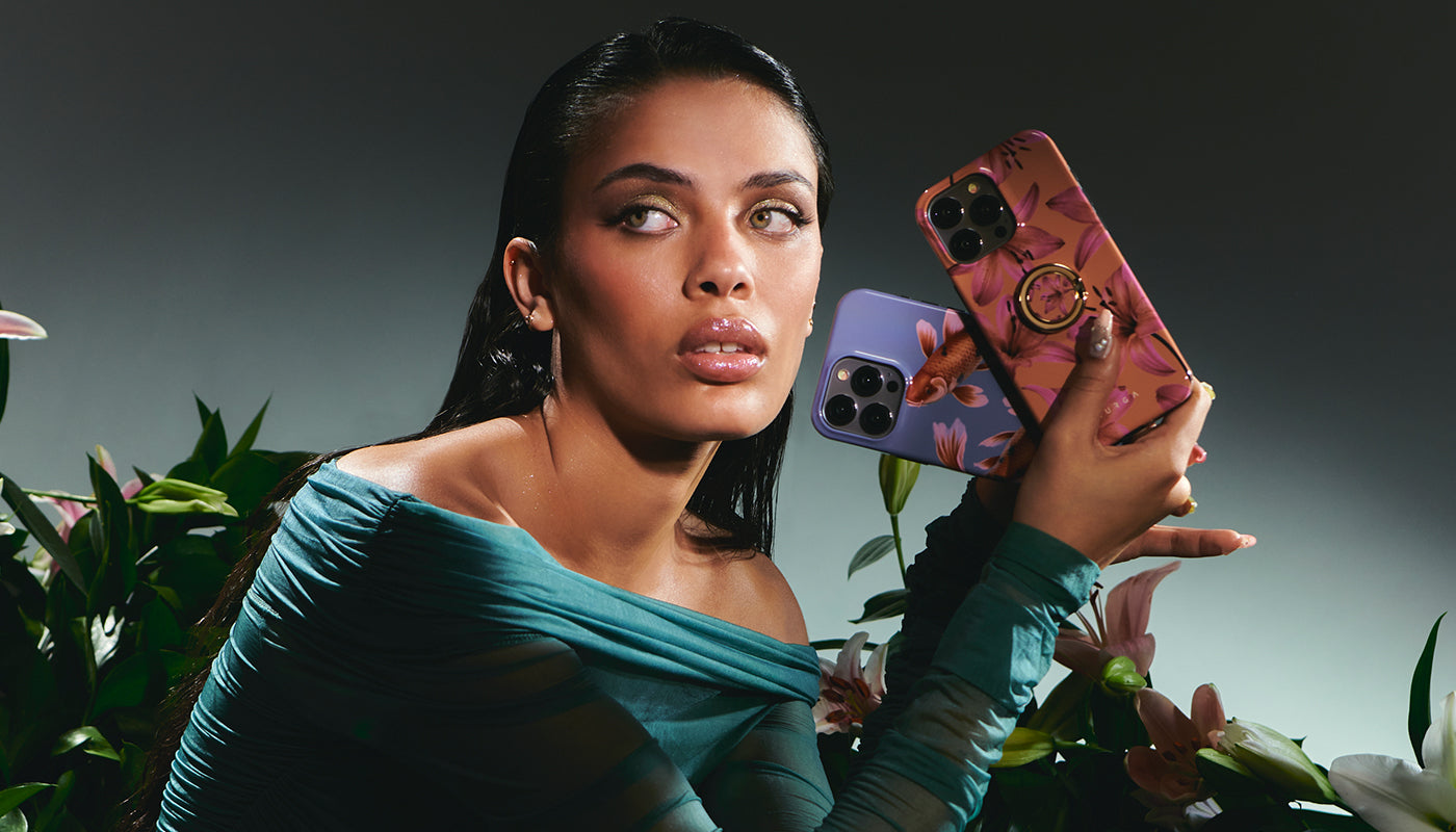A woman holding a smartphone with a Secret Garden case, looking away from the camera with a thoughtful expression.