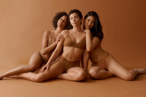Three woman in bamboo viscose underwear, sitting on the floor