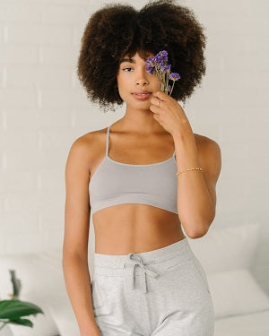 Model wearing racerback bra and grey joggers 