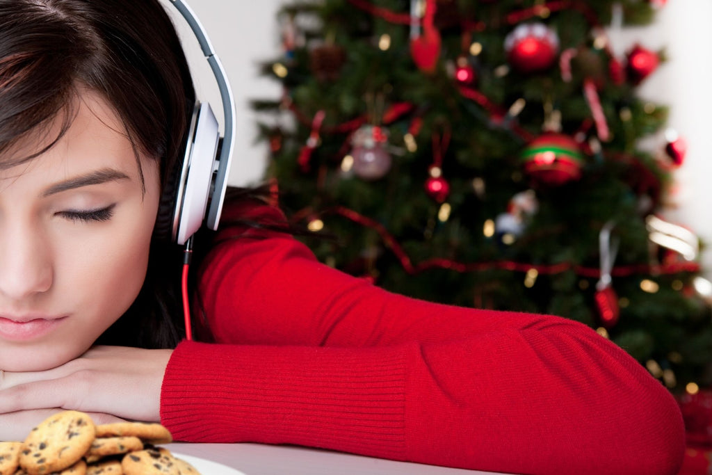 Girls listening to Christmas music with cookies and Christmas Tree