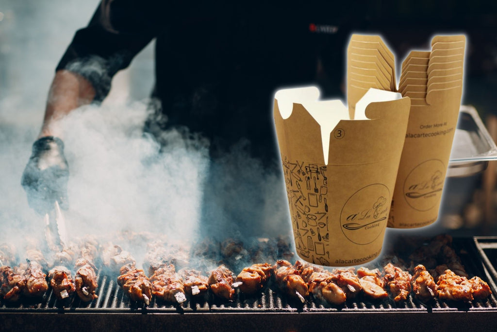 Chicken wings and legs grilled with grease bucket liners in view of man grilling