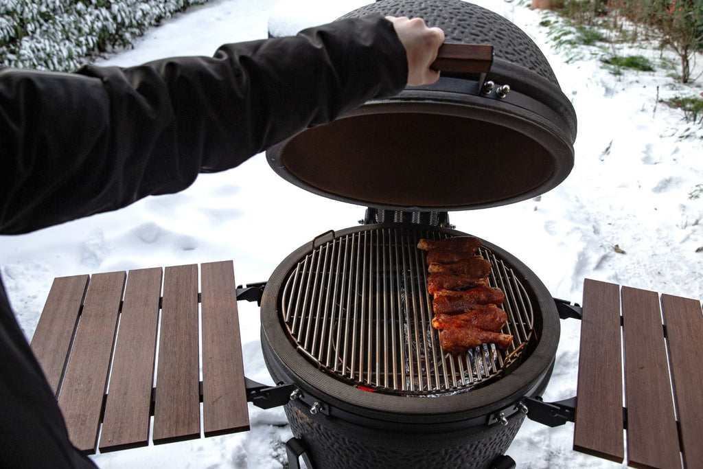 charcoal grilled meet on green egg in snow