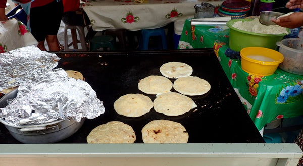 Pupusa con queso y frijoles, a typical Salvadoran thick corn tortilla stuffed with cheese and beans 
