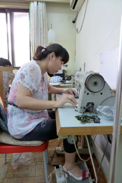 Unbelts' first sewist sews stretch belts at her machine in Shanghai, China.