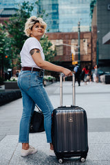 Woman wearing stretch belt with suitcase