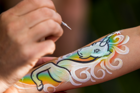 a child getting body paint