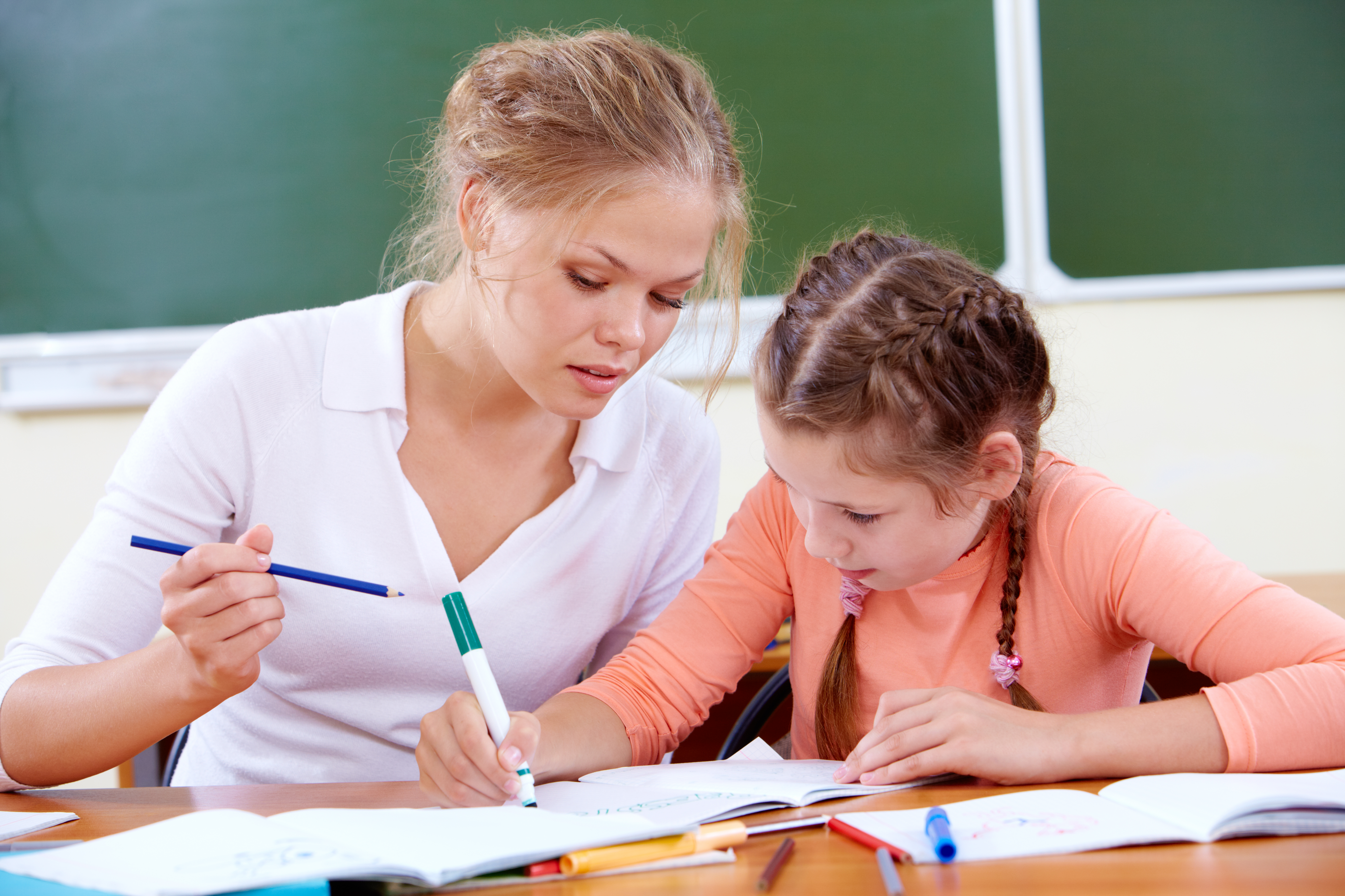 child doing drawing exercises with her mother