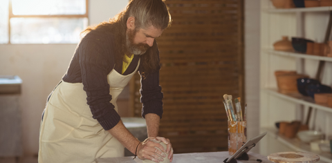 a boy molding a clay