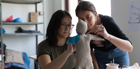 two girls making sculpture art