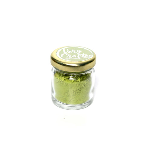 Small glass jar of powdered green tea Matcha