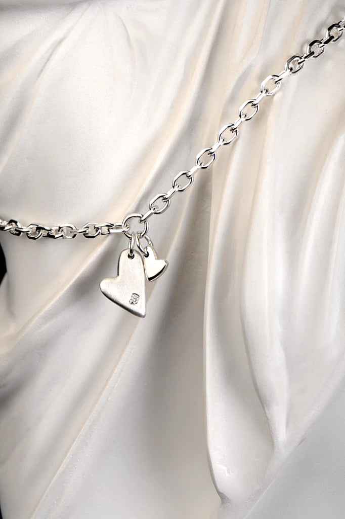 designer silver heart bracelet set with a diamond