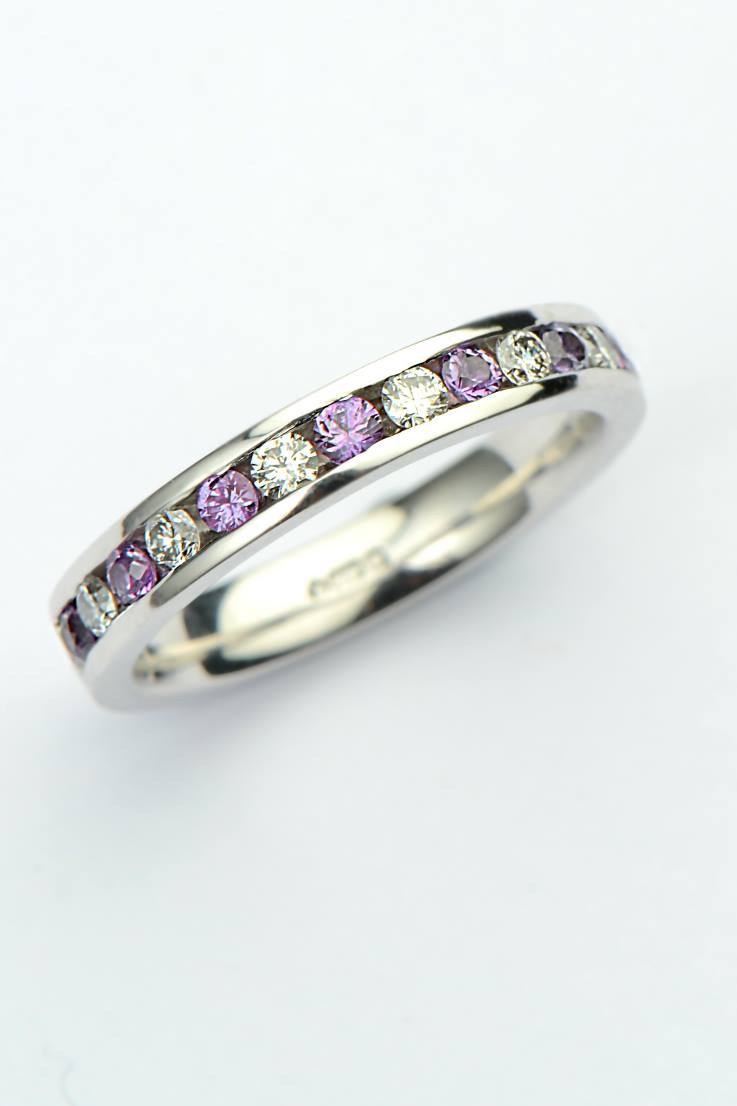 purple sapphire and diamond channel set eternity ring