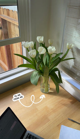 fresh flowers white tulips on kitchen table 