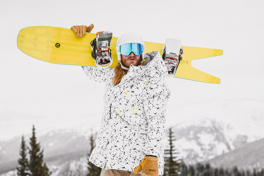 a man with a snowboard wearing goggles