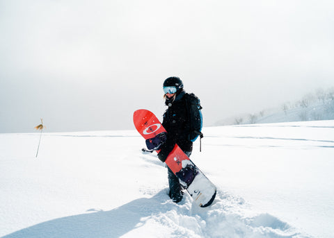 a snowboarder with goggles in winter