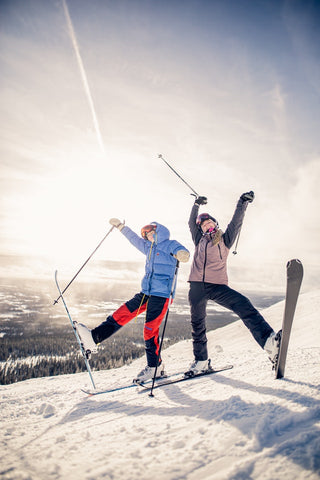 two persons with skis