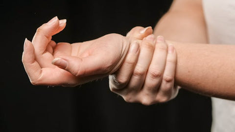 woman holding her wrist