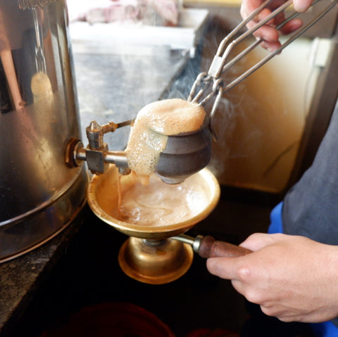Chai Wallah in India preparing hot chai.