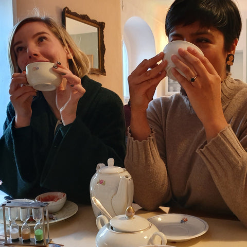 Krisi and Uppma drinking cups of tea.