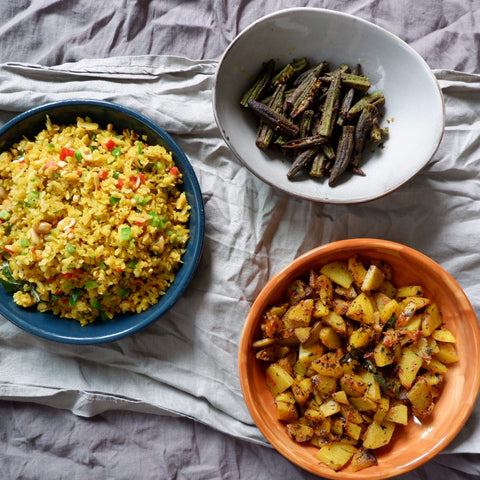 Uppma's indian rice dish next to cooked okra and dhal.
