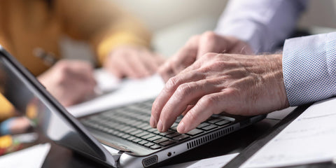 man on computer with light