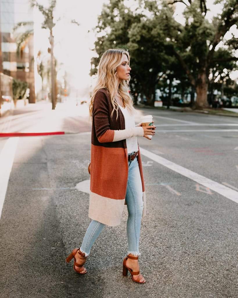 a woman standing on a sidewalk