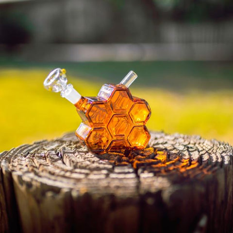 A photo of a bong shaped like a honeycomb