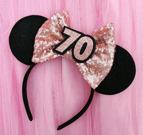 soft black minnie mouse ears with a rose gold sequin bow and rose gold 70 in the centre made by Luby&Lola