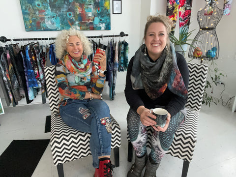 Wendy Fee and Reni Fee sitting on chairs in their Valois Village Art Studio called Artist Generations