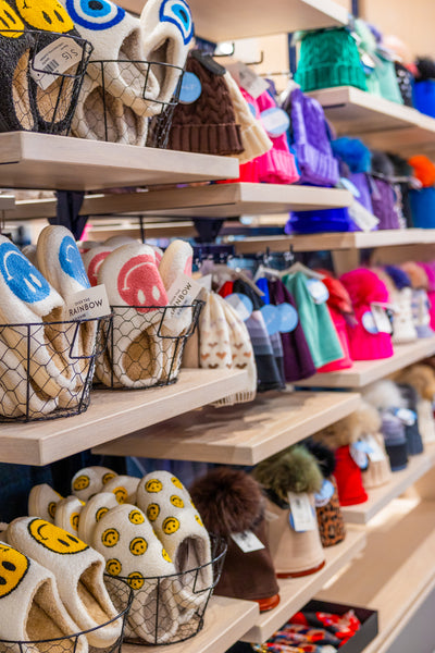 Over The Rainbow Women's Lim Lim Slippers and Lindo F hats on display