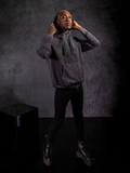 Braxton in a staggered stance wearing a distressed colored goth style outfit. 