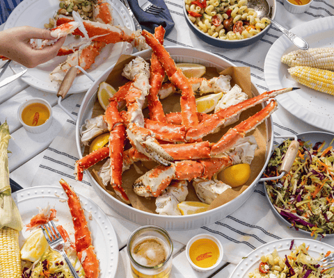 Large Seafood meal spread with bowl of King Crab in the center