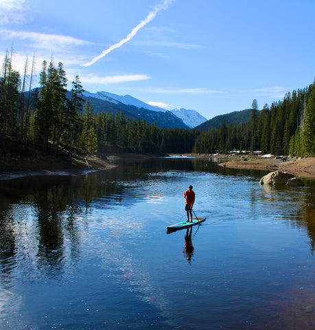 A person paddleboarding on Lake Granby in Colorado.