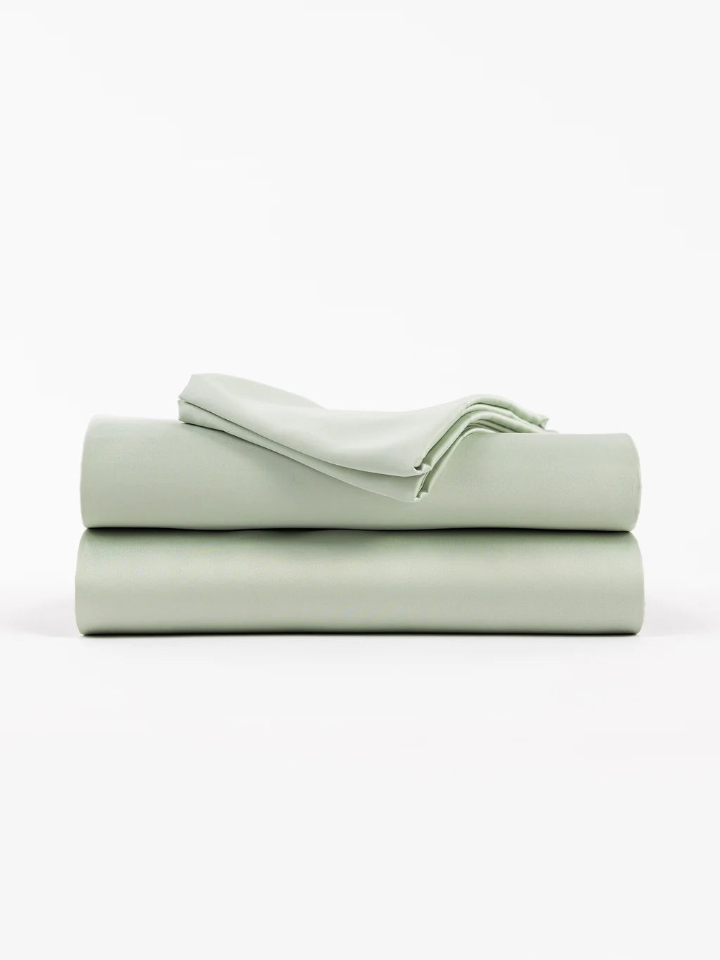 A folded stack of light green bed sheets on a white background.