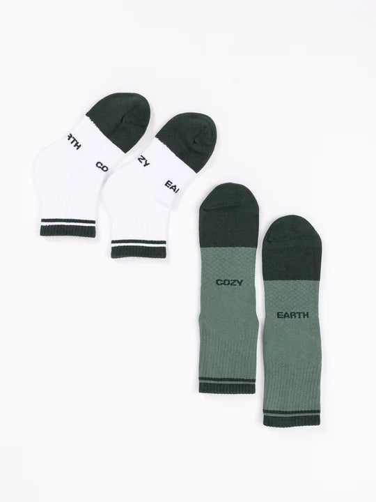 Two pairs of 'Cozy Earth' socks, in white and green, displayed on a white background.