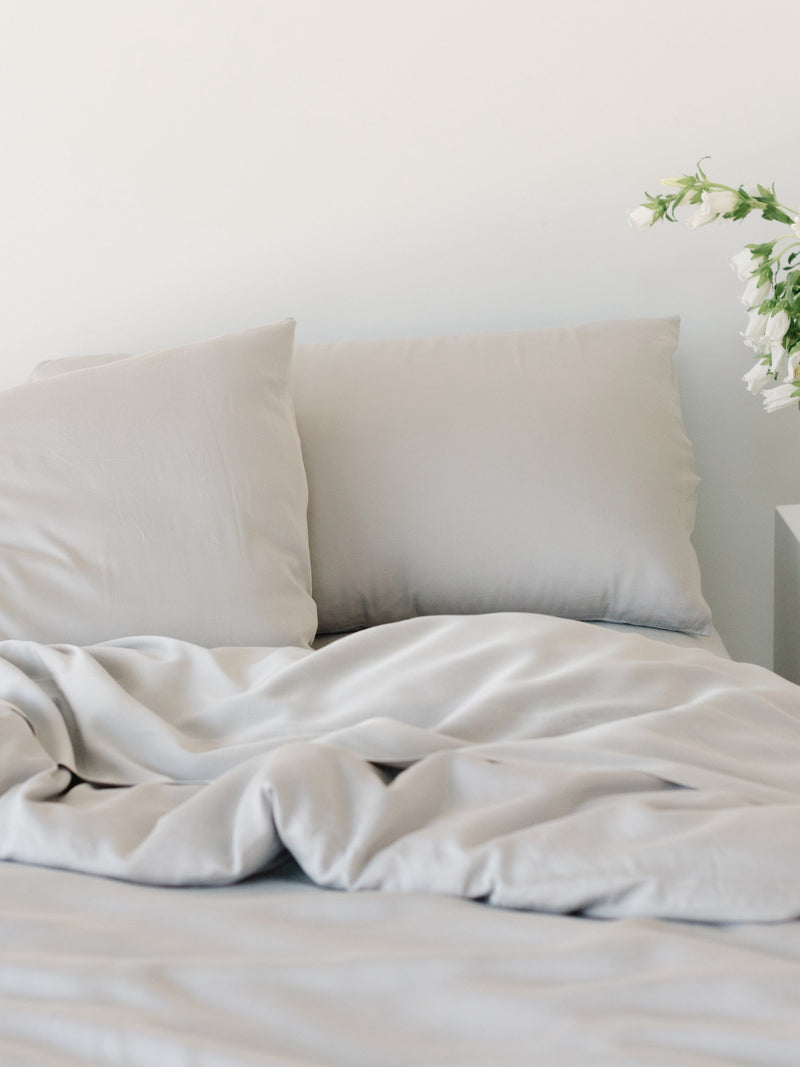 Unmade bed with light grey bedding |Color:Light Grey