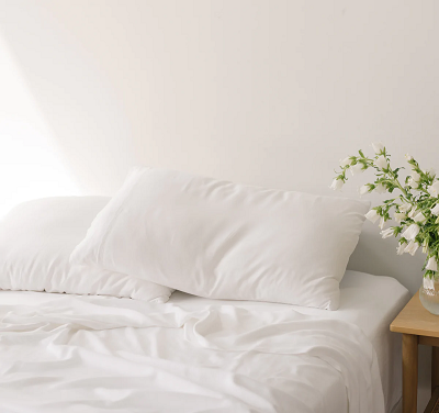 White bamboo sheets & pillows on a bed