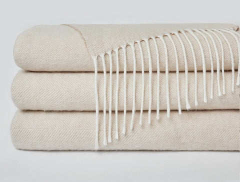 3 Herringbone Tassel Throw Blankets stacked on top of each other