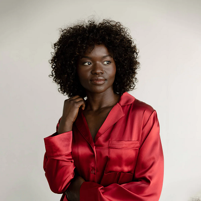Woman wearing red silk Cozy Earth PJ top
