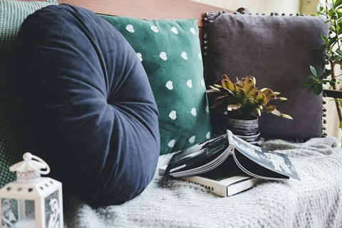 Plush reading area with pillows and books