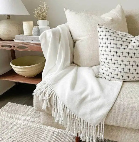 Cozy Earth throw blanket draped over couch arm and cushion