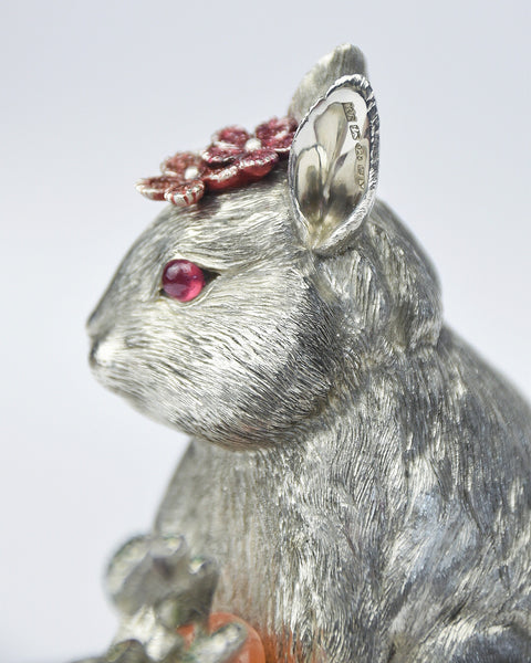 Detail of silver rabbit sculpture showing hallmark on the inside of the ear
