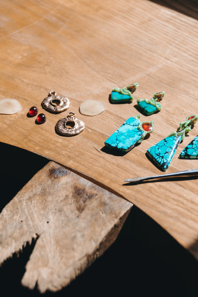 Jewellery bench with wax sculpted over slices of turquoise which are prepared to enter the Lava collection series by TVRRINI