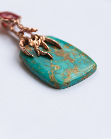 Detail of Lava Pendant II featuring turquoise and orange sapphire set in 18K rose gold