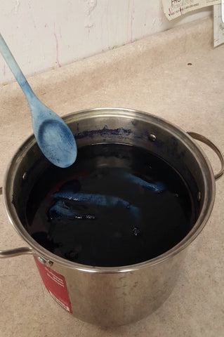 Indigo vat in steel pot with stirring spoon