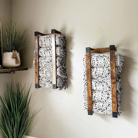 Two brown-stained, industrial style, vertical wall towel racks.