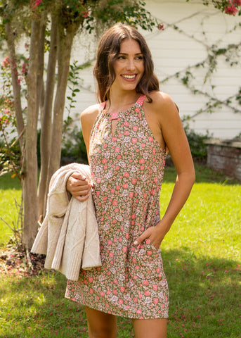 Woman wearing Jetties Beach Sleeveless Shift Dress holding sweater